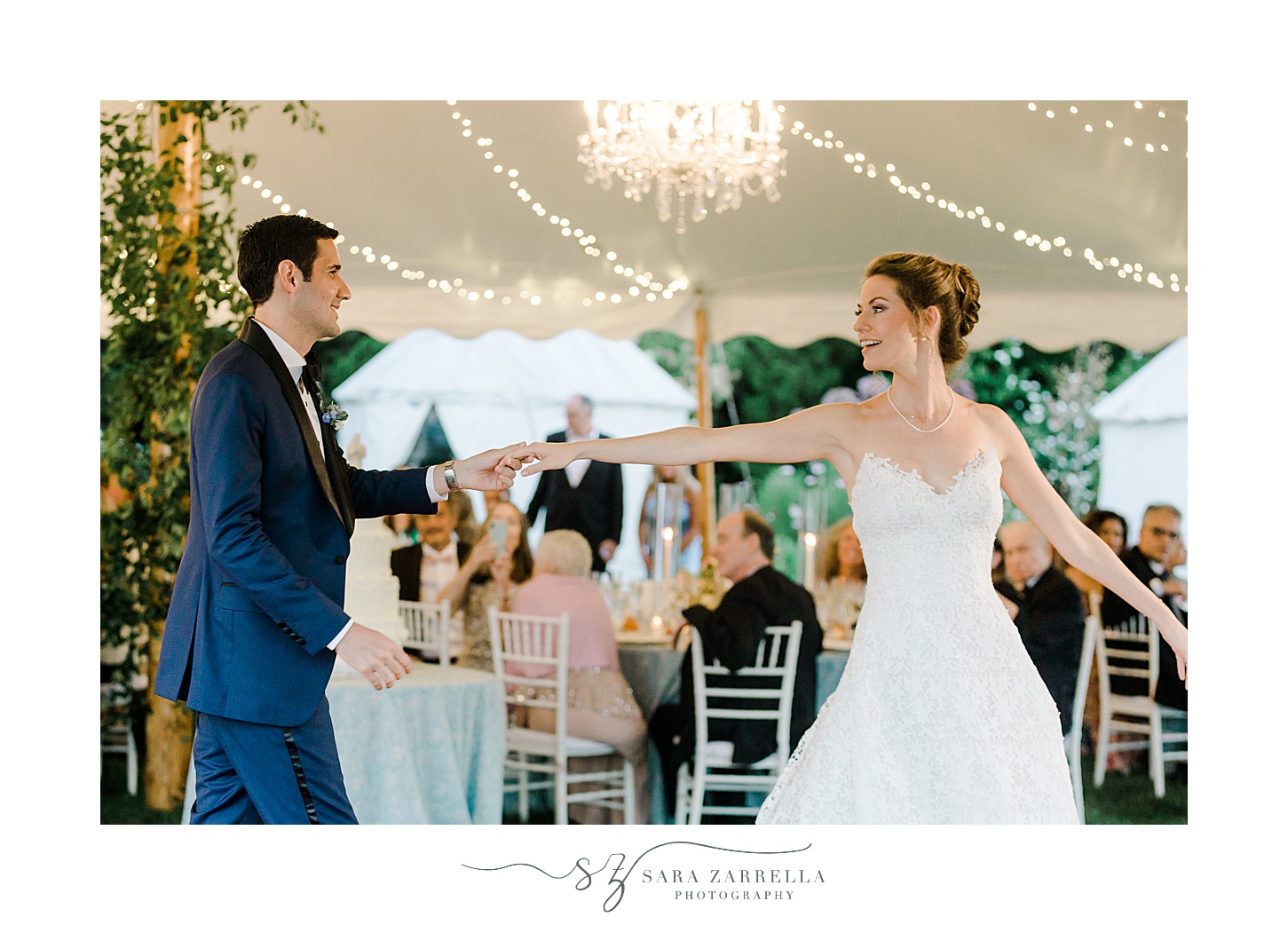 groom twirls bride during dance under tent at the Chanler in Newport RI
