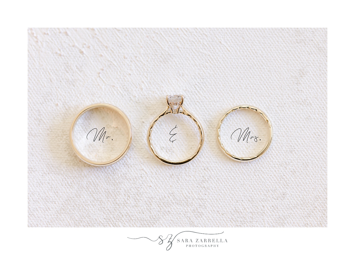 three gold wedding rings lay over mr and mrs script 