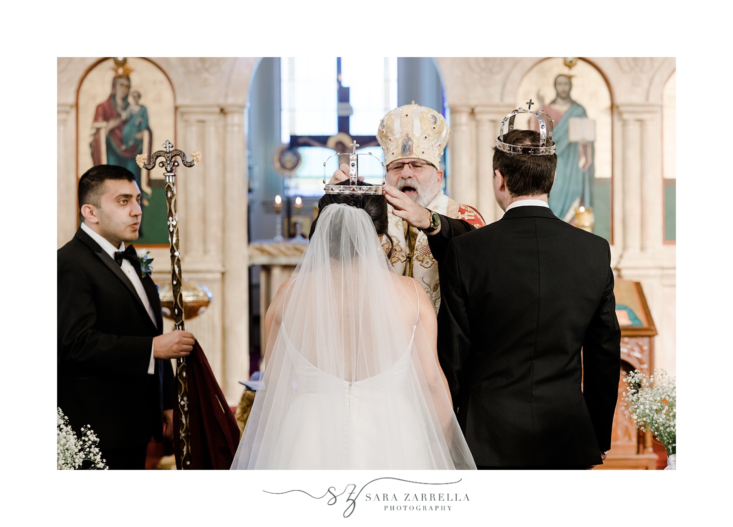 father puts crown on bride's head during traditional Greek Orthodox ceremony inside Saint Mary Antiochian church
