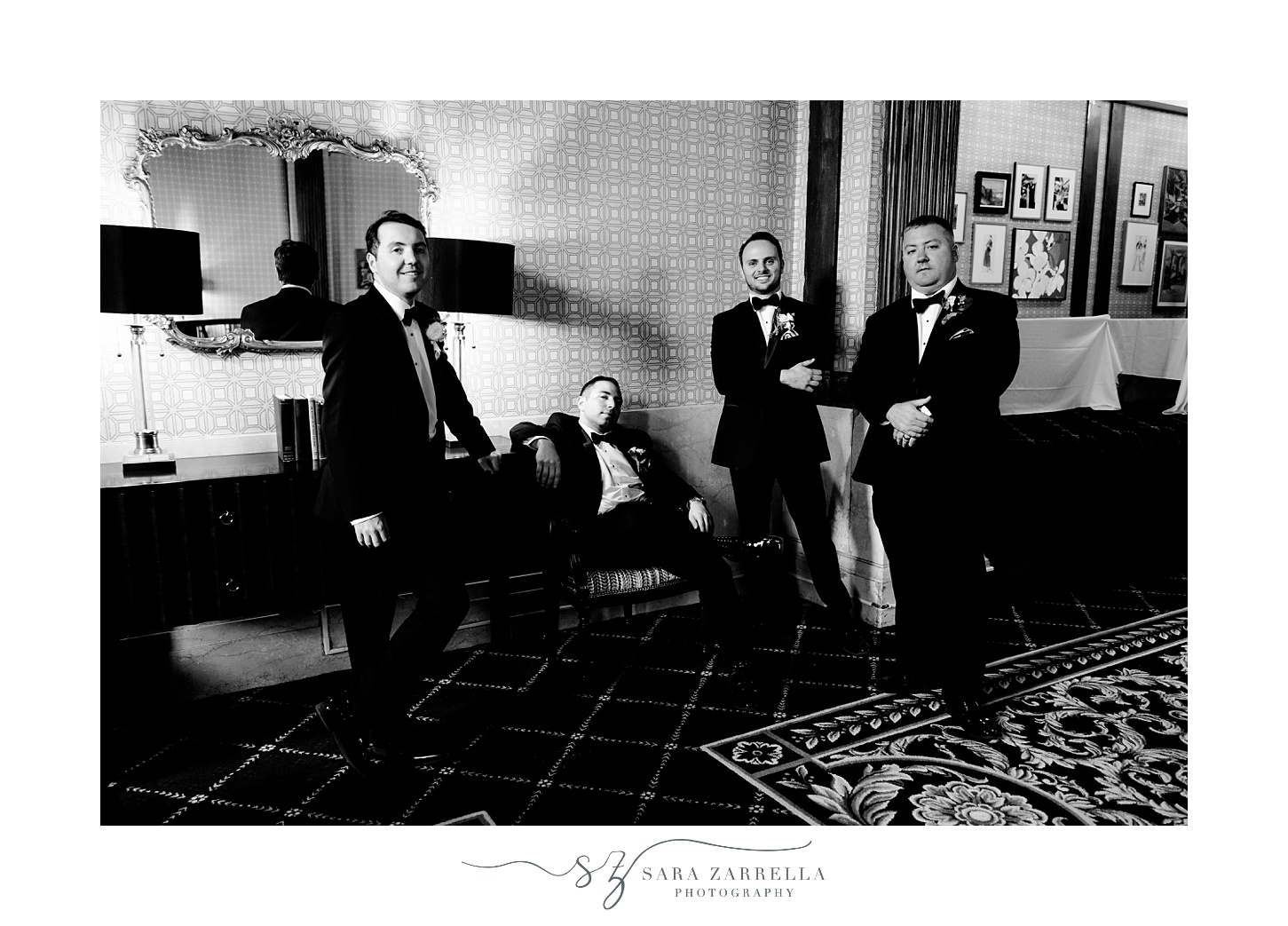 groom sits with groomsmen in lobby of the Graduate Providence