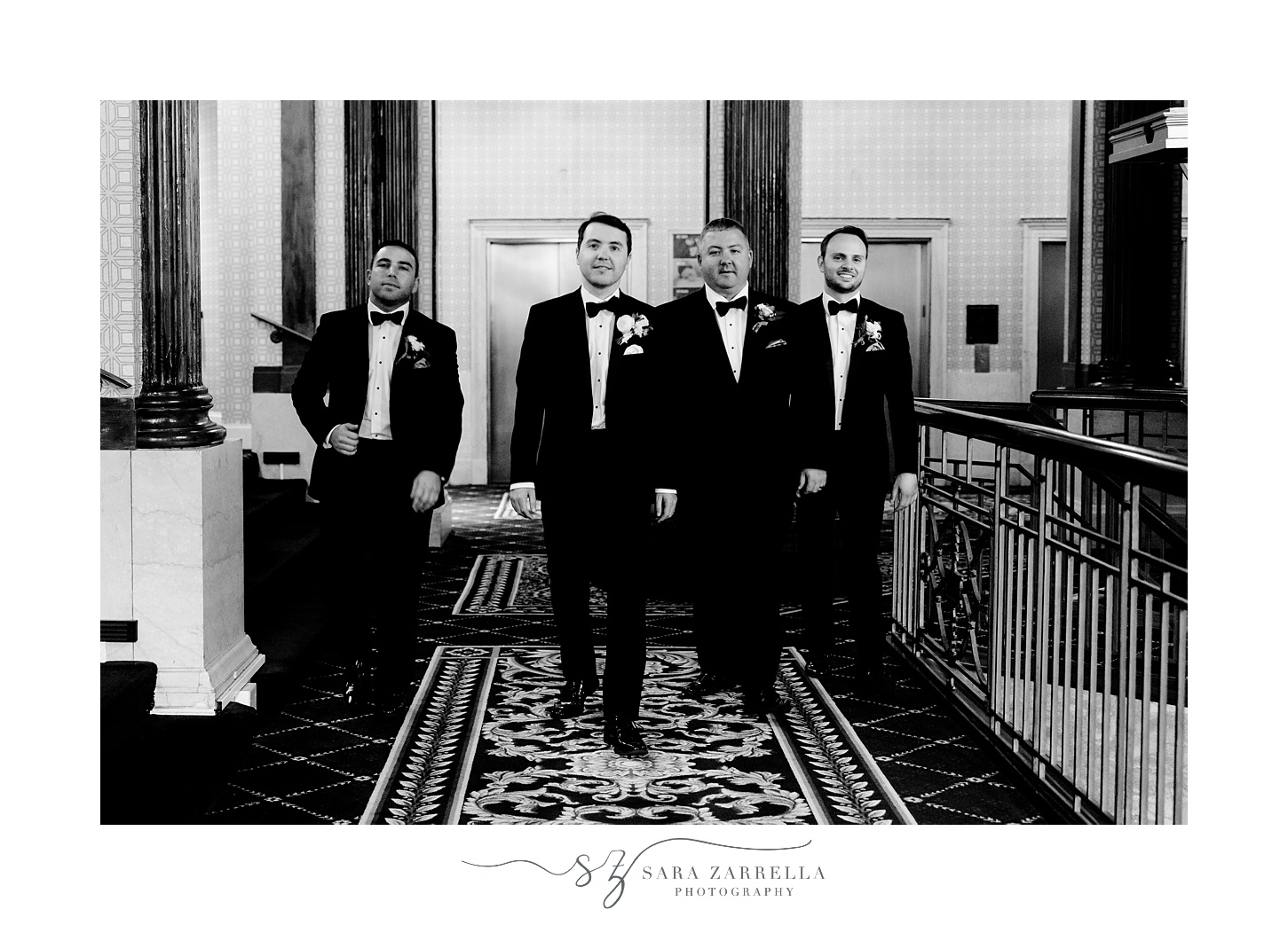 groom walks through lobby with groomsmen at the Graduate Providence
