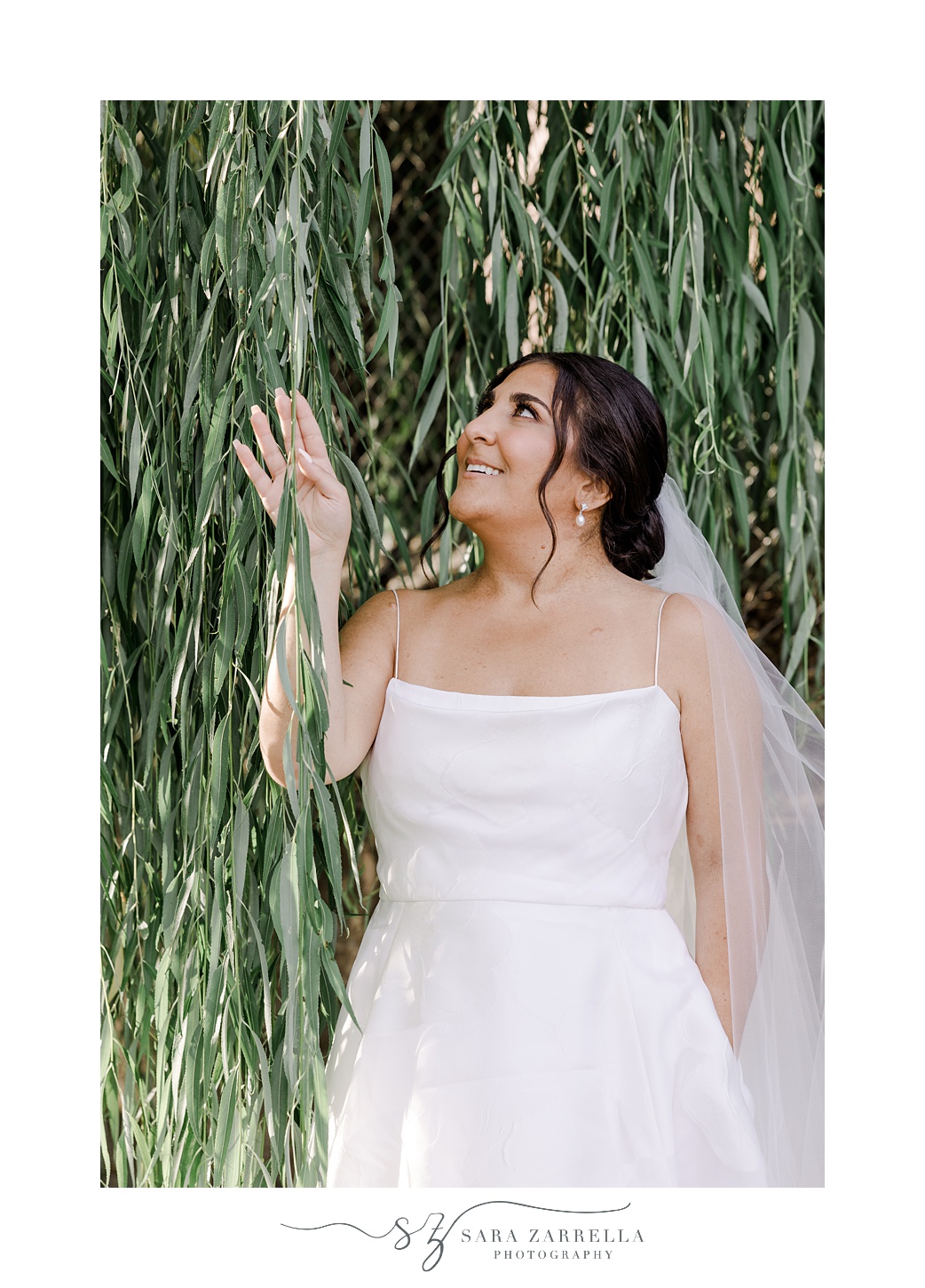 bride smiles up at leaves of weeping willow in Providence RI