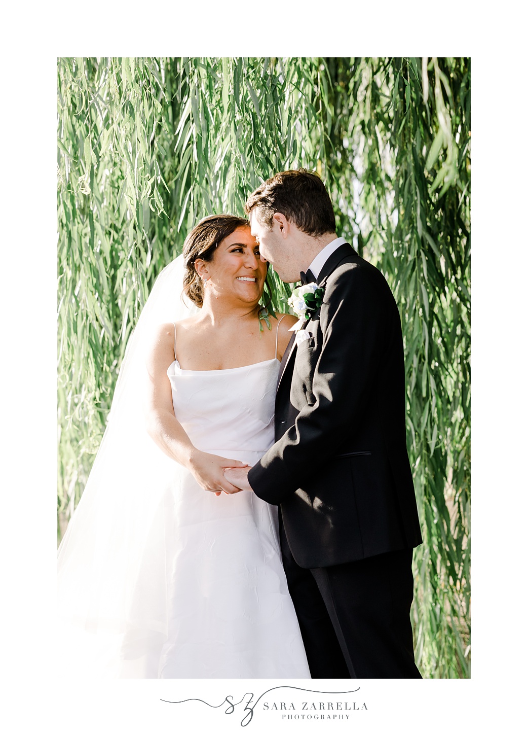 newlyweds smile under weeping willow together in Providence RI