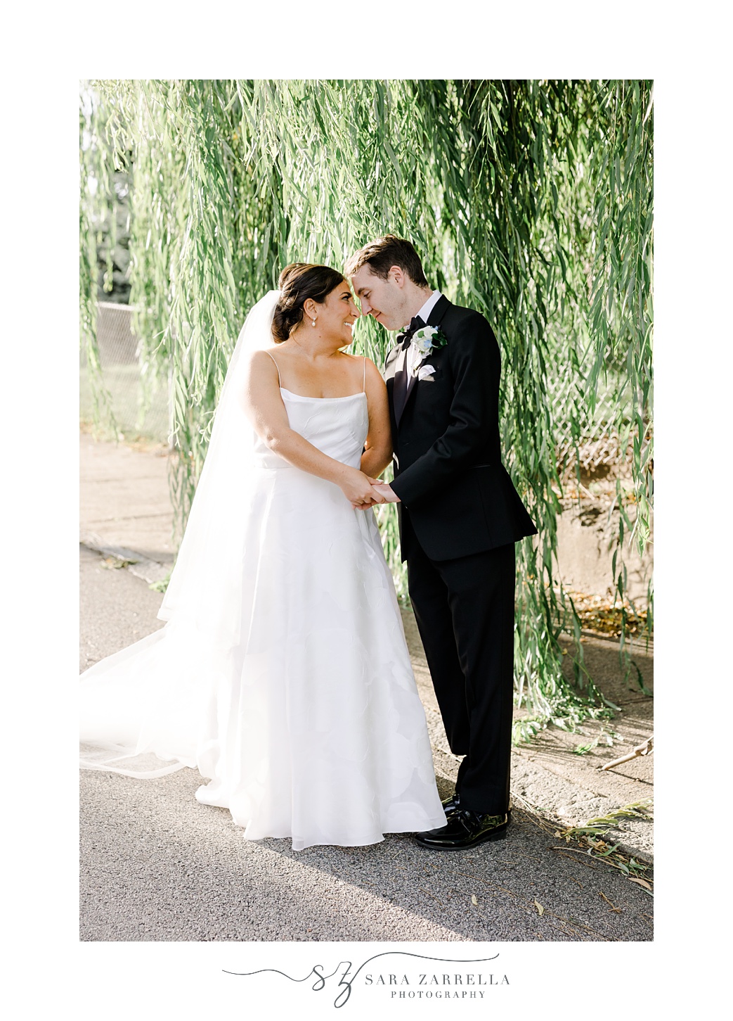 bride and groom hug under weeping willow in Providence RI