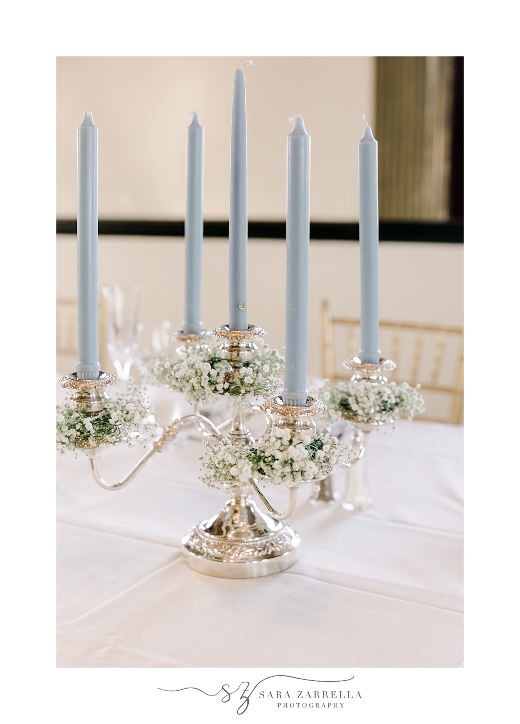 blue taper candles with gold holder at the Graduate Providence