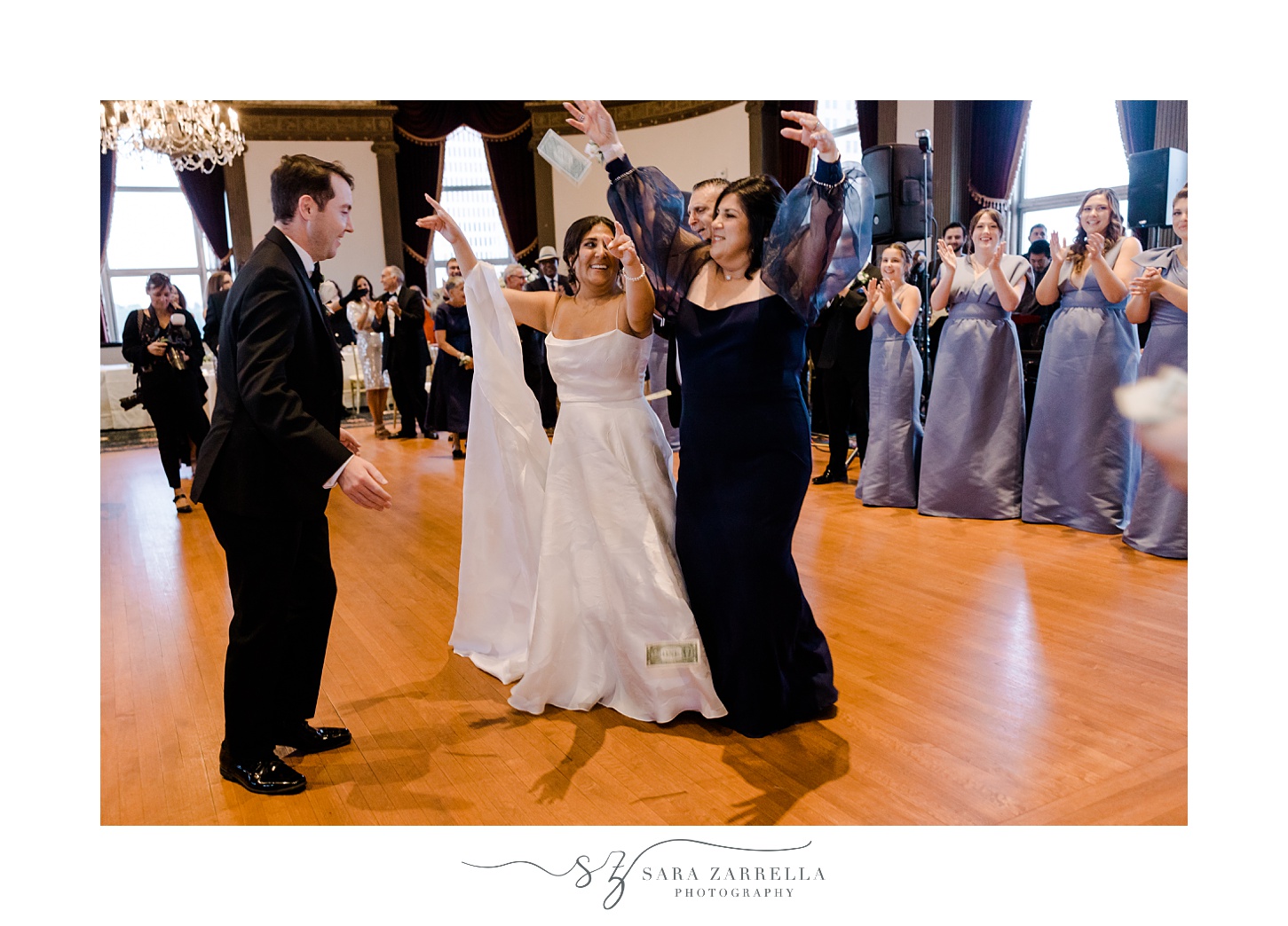 bride and groom dance surrounded by wedding party during Providence RI wedding reception