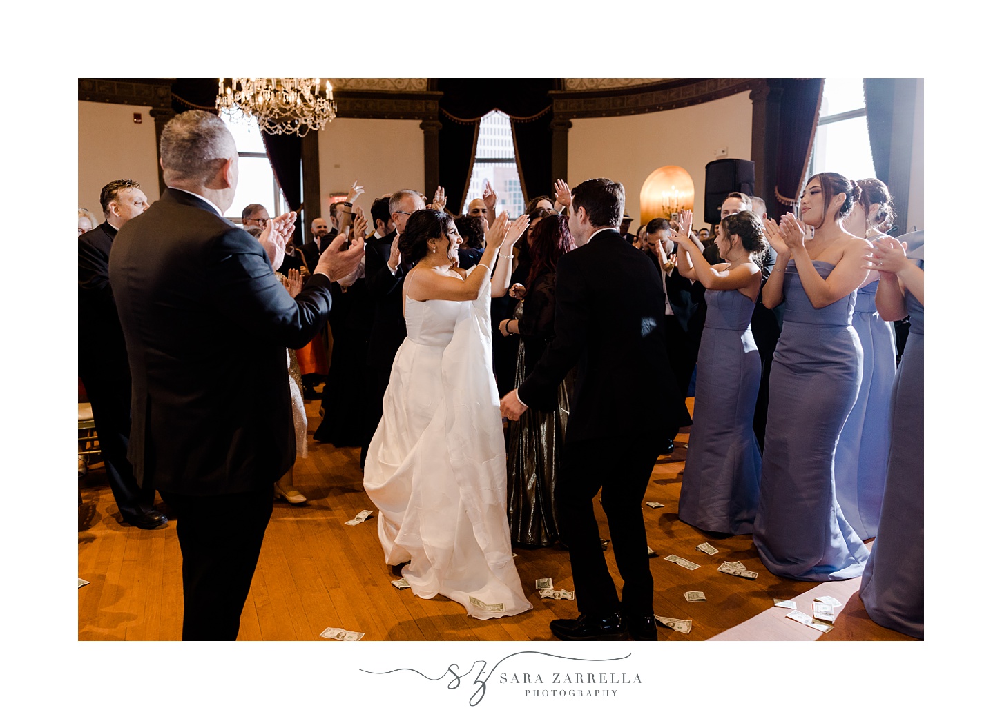 bride and groom dance surrounded by wedding party during Providence RI wedding reception