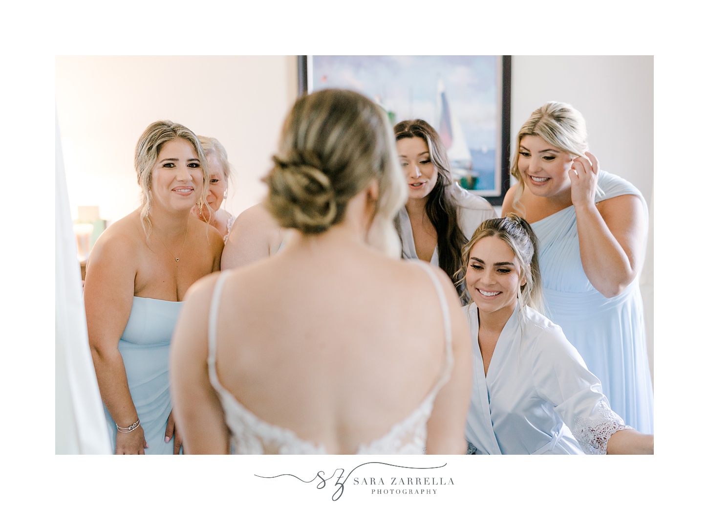 bride shows off wedding look to bridesmaids at Regatta Place