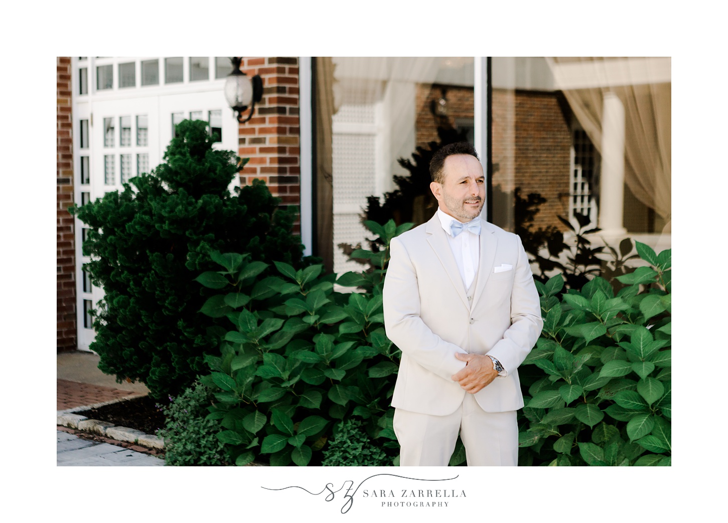 groom waits for bride for first look outside Regatta Place