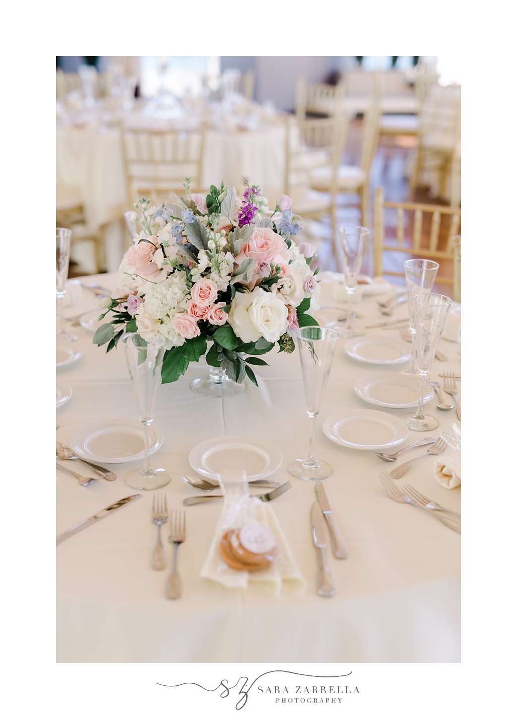 wedding reception at Regatta Place with pink and white floral centerpiece 