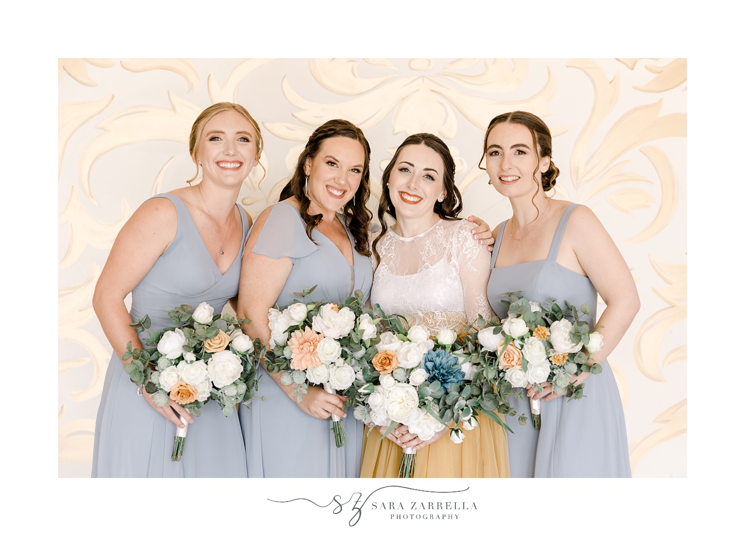 bride hugs bridesmaids in blue gowns with silk bouquets at the Atlantic Wyndham Resort