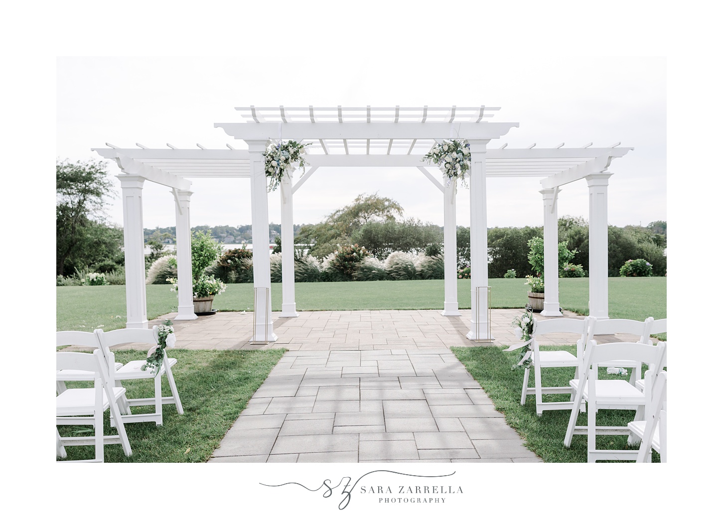 white flowers hang on white arbor on patio for outdoor wedding ceremony at the Atlantic Wyndham Resort