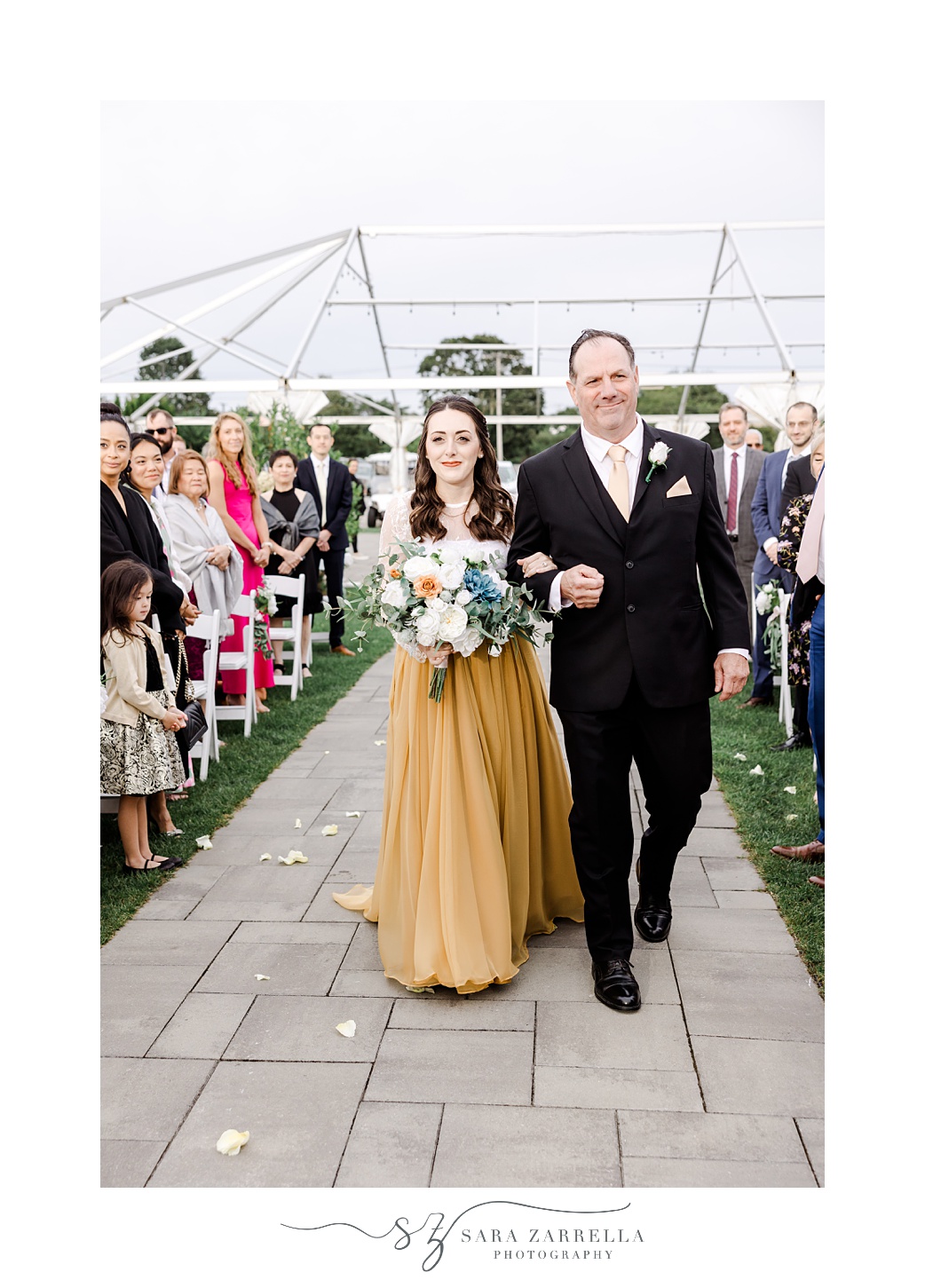 bride and father walk down aisle during outdoor wedding ceremony at the Atlantic Wyndham Resort
