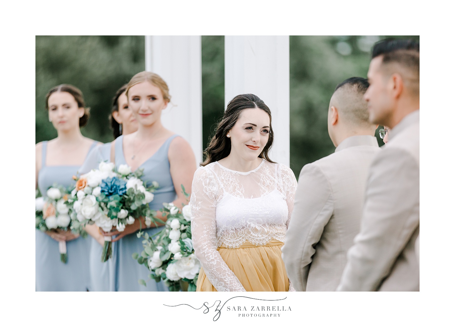 bride in lace top and gold skirt smiles at groom during outdoor wedding ceremony at the Atlantic Wyndham Resort