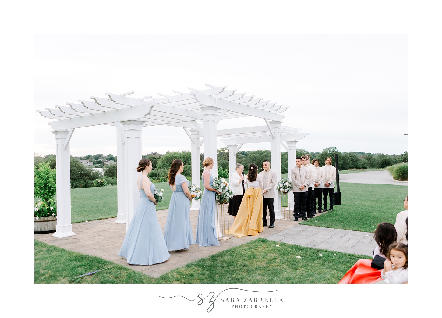bridal party watches outdoor wedding ceremony at the Atlantic Wyndham Resort