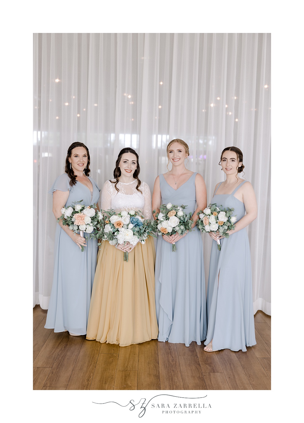 bride and bridesmaids in blue gowns hold silk bouquets at the Atlantic Wyndham Resort