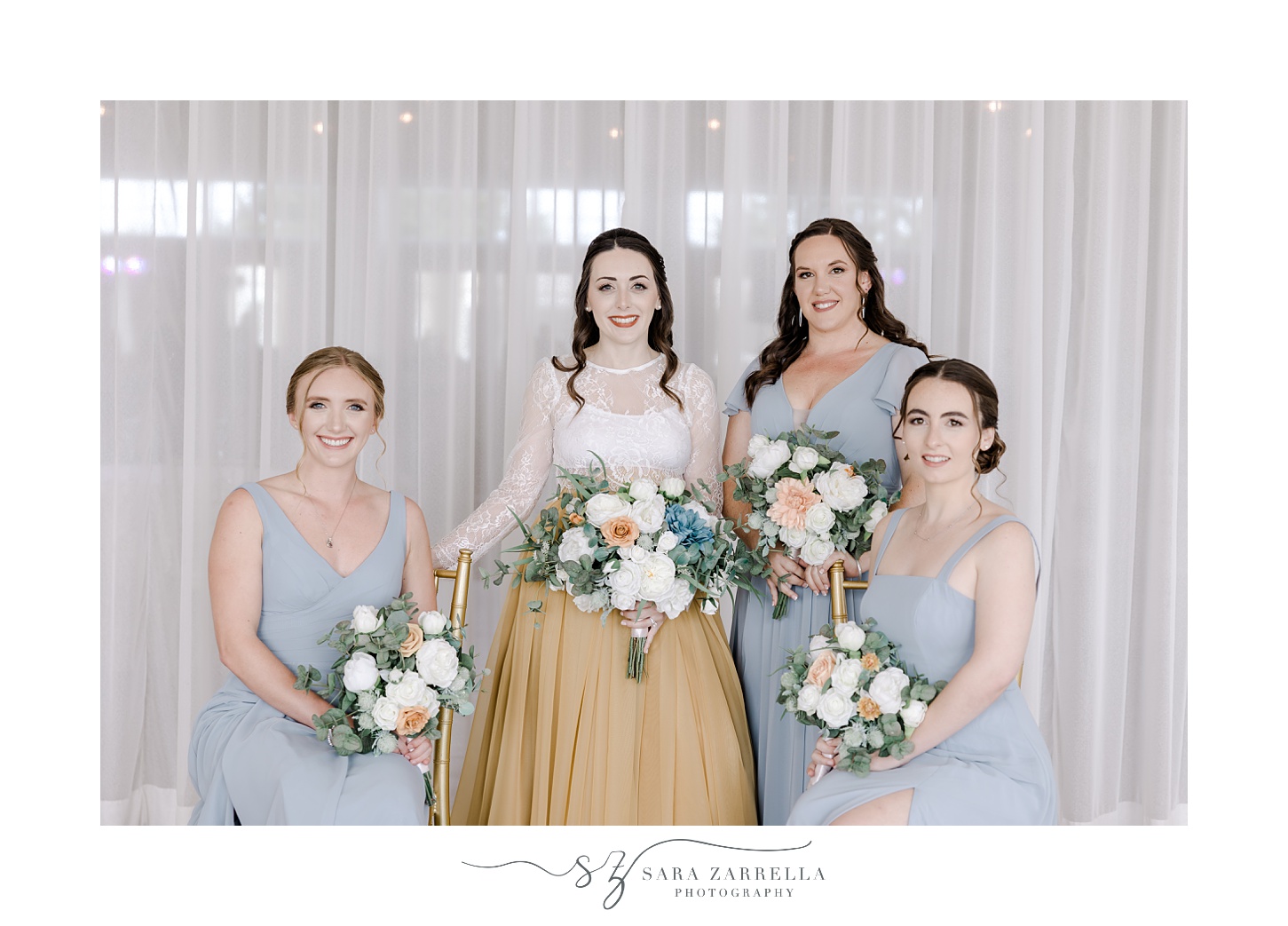 bride stands with bridesmaids in blue gowns at the Atlantic Wyndham Resort