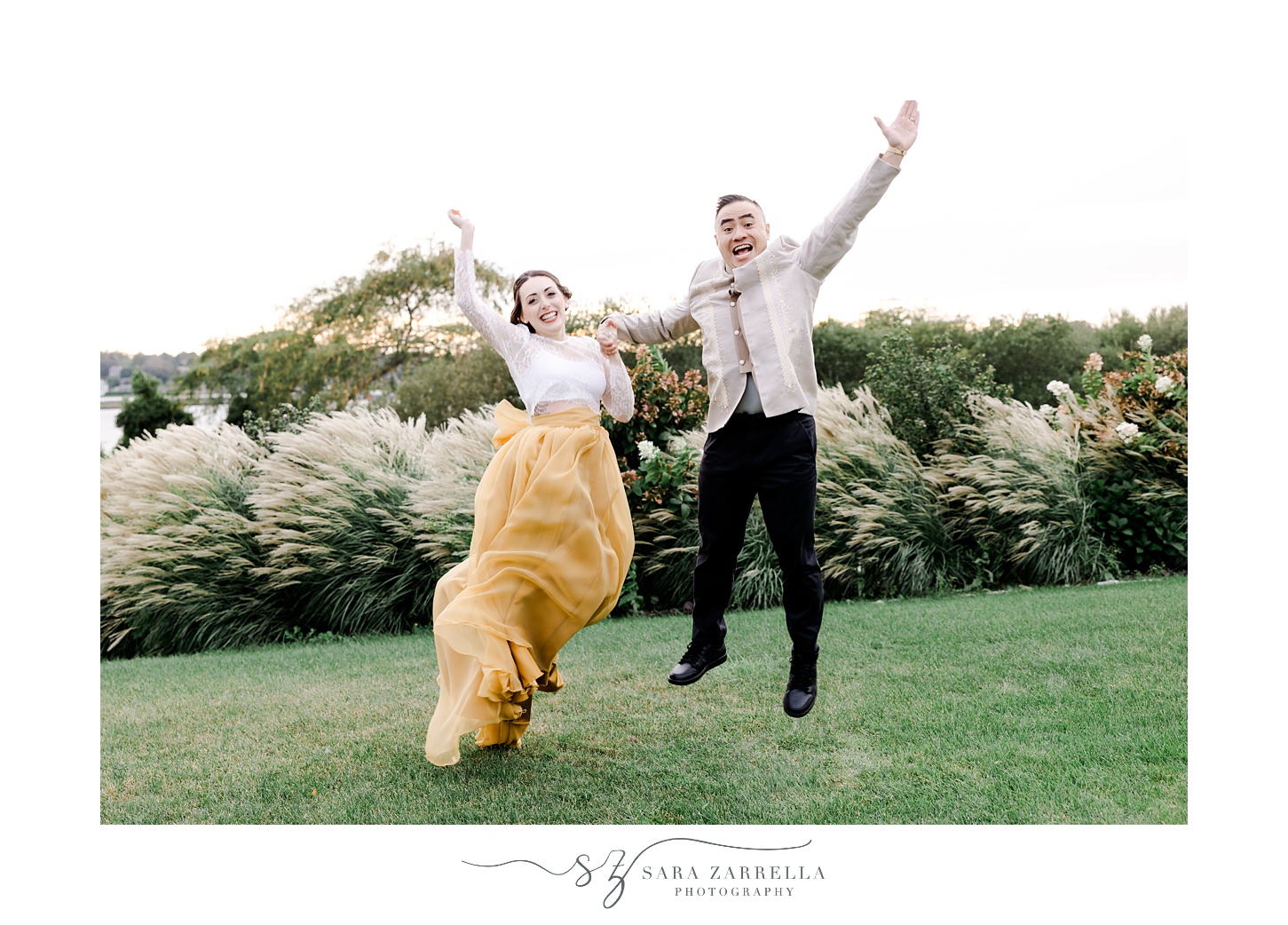 bride and groom jump on hill at the Atlantic Wyndham Resort
