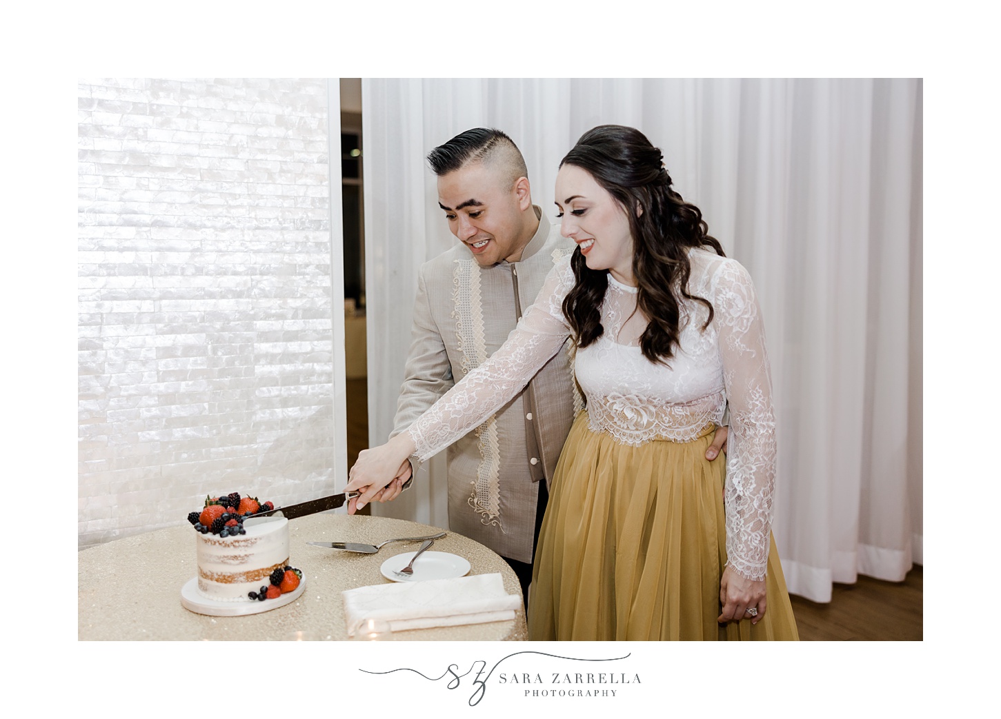 newlyweds cut small cake during Rhode Island wedding reception 
