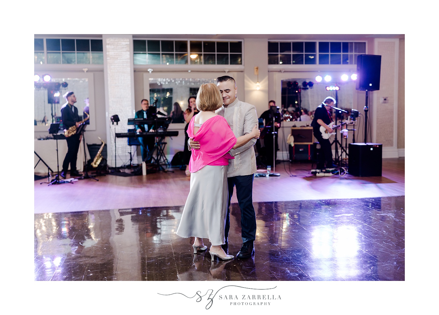 groom dances with mother in pink top during Rhode Island wedding reception 