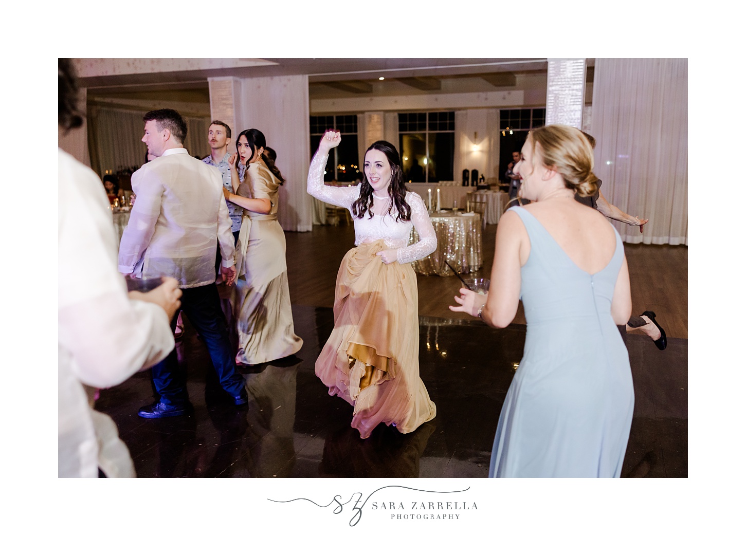 bride in gold skirt and lace top dances during Rhode Island wedding reception 