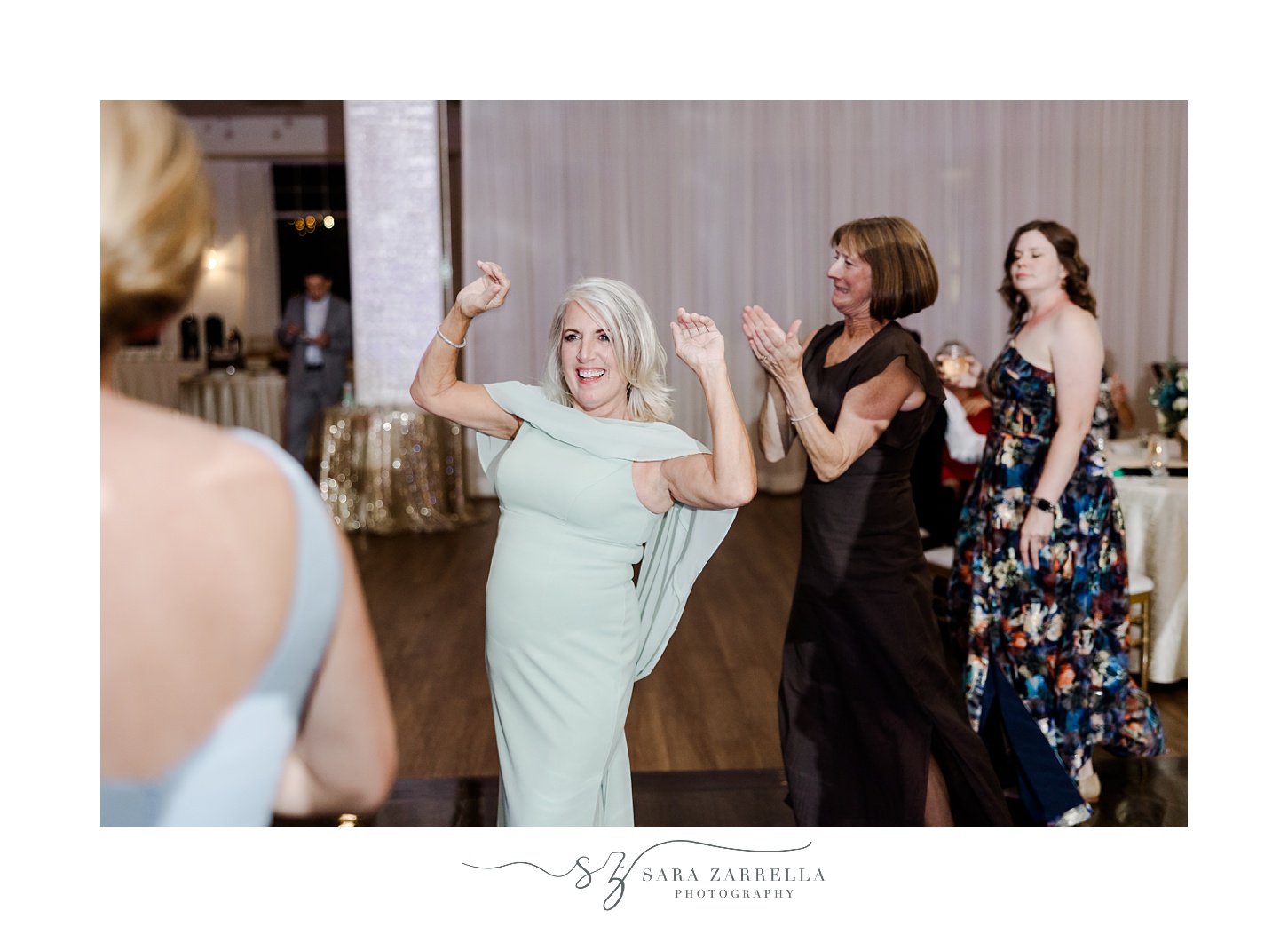 woman in green dress dances during Rhode Island wedding reception 