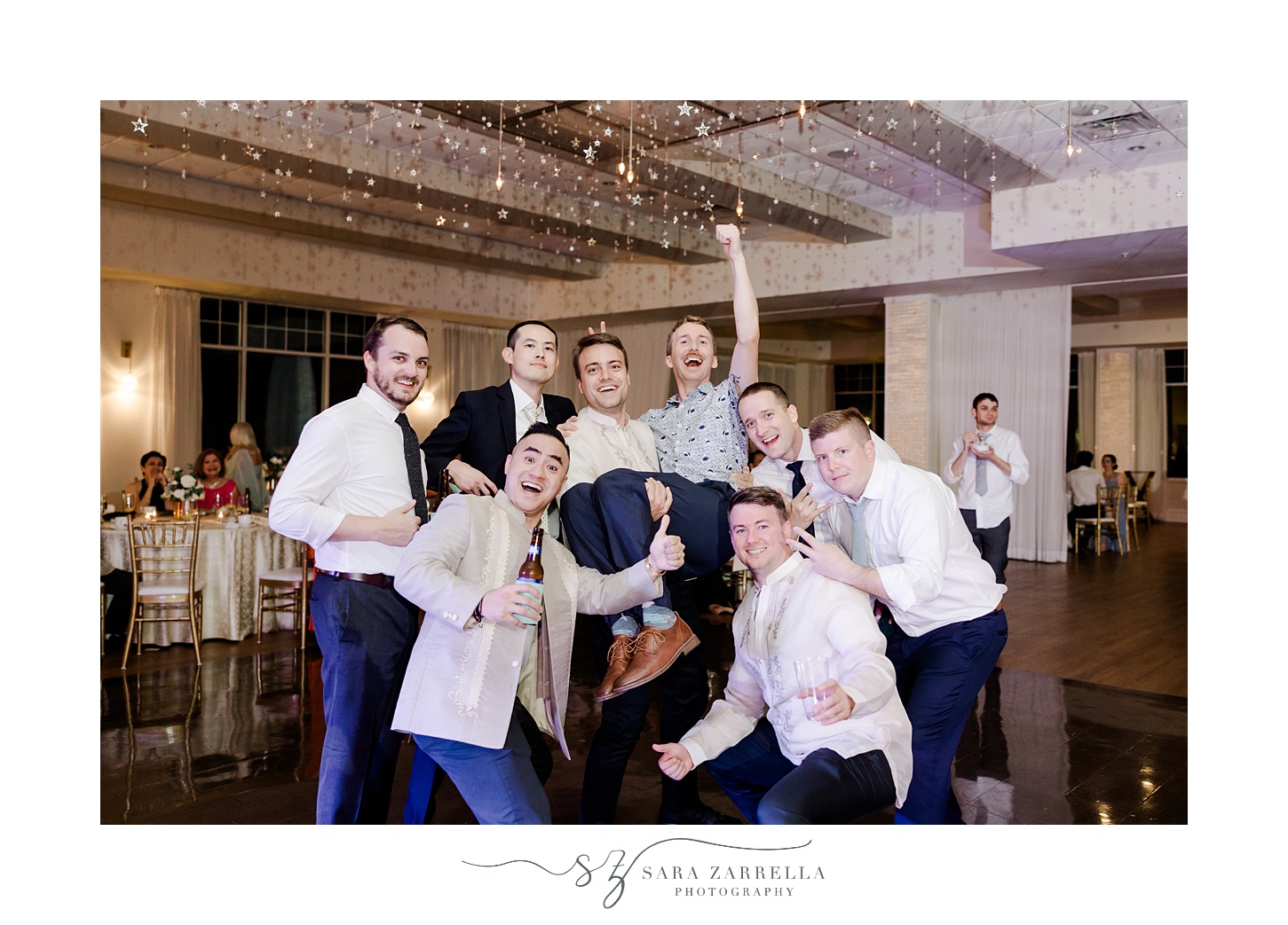 groomsmen lift up groom on dance floor in Rhode Island reception 