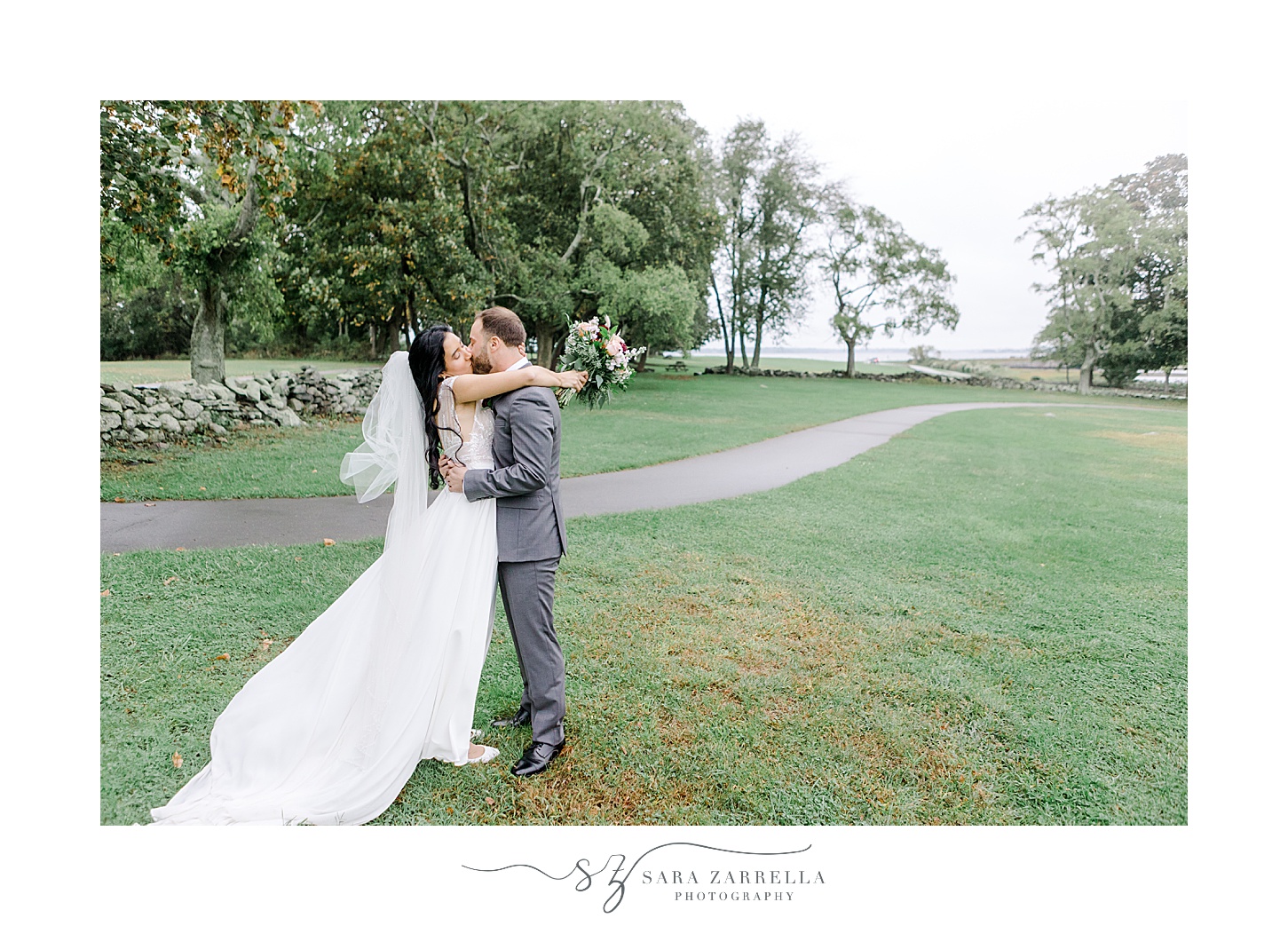 bride and groom kiss along path inside Colt State Park