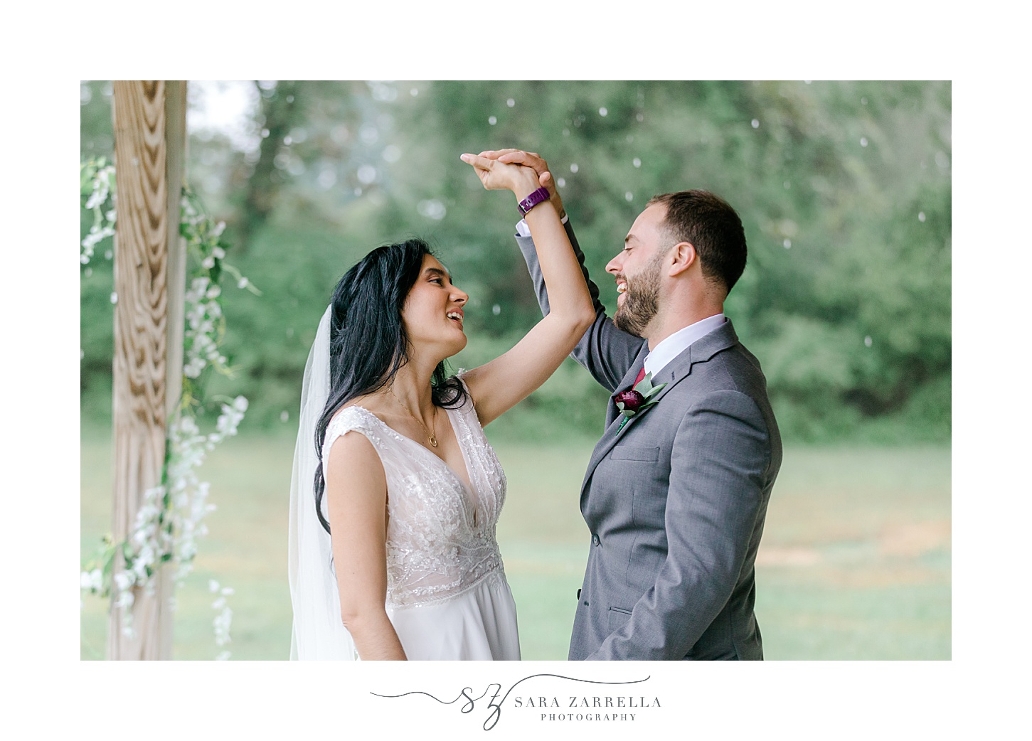 groom twirls bride inside Colt State Park on rainy day