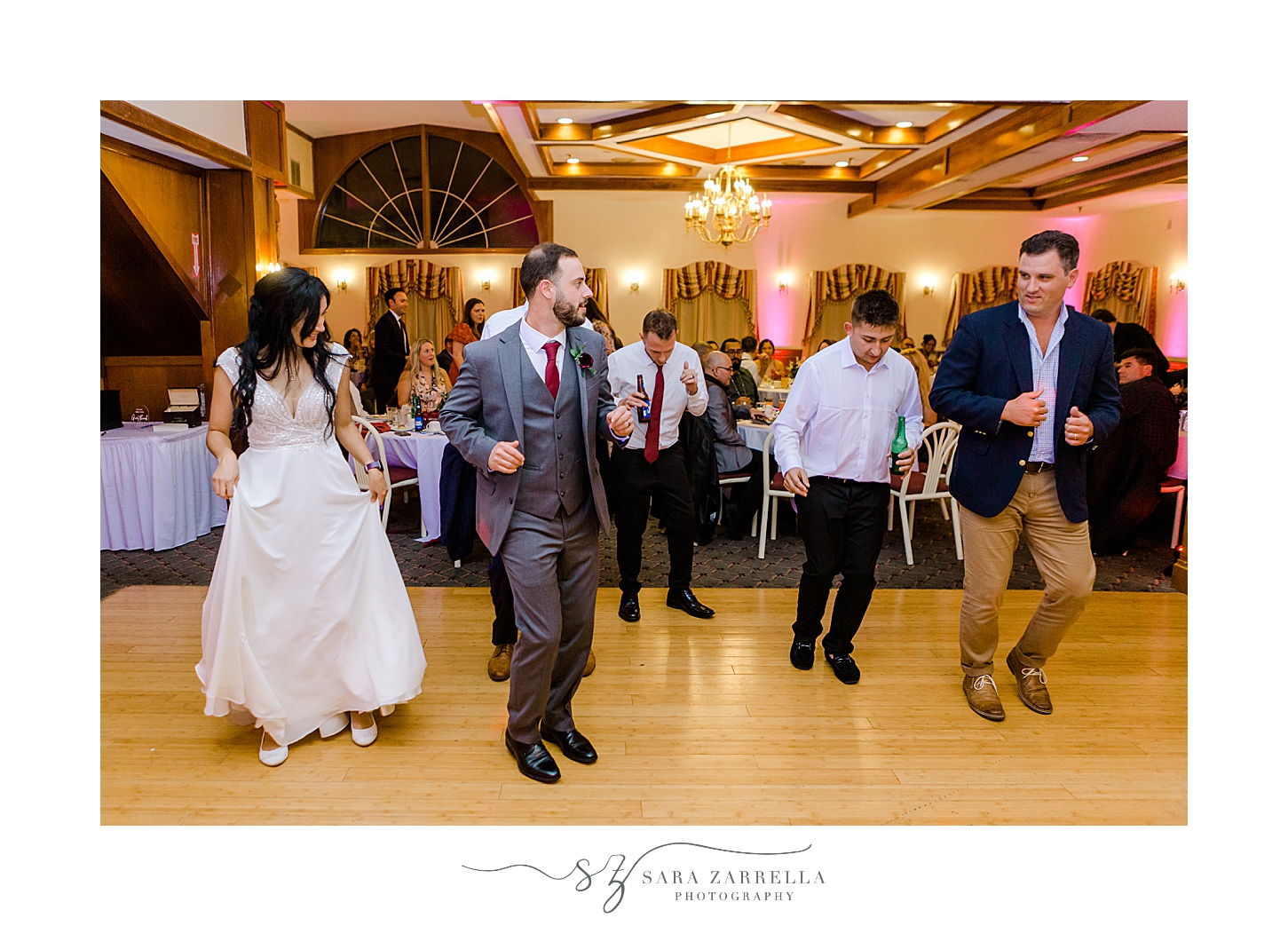 newlyweds dance with guests during wedding reception at Jacky's Galaxie