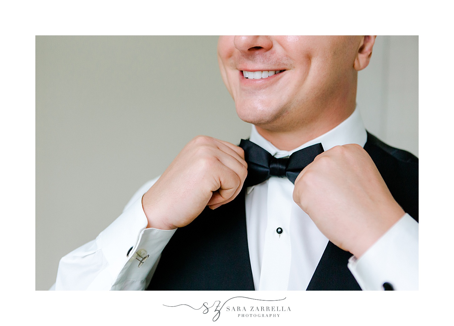 groom adjusts tie while preparing for Newport RI wedding day