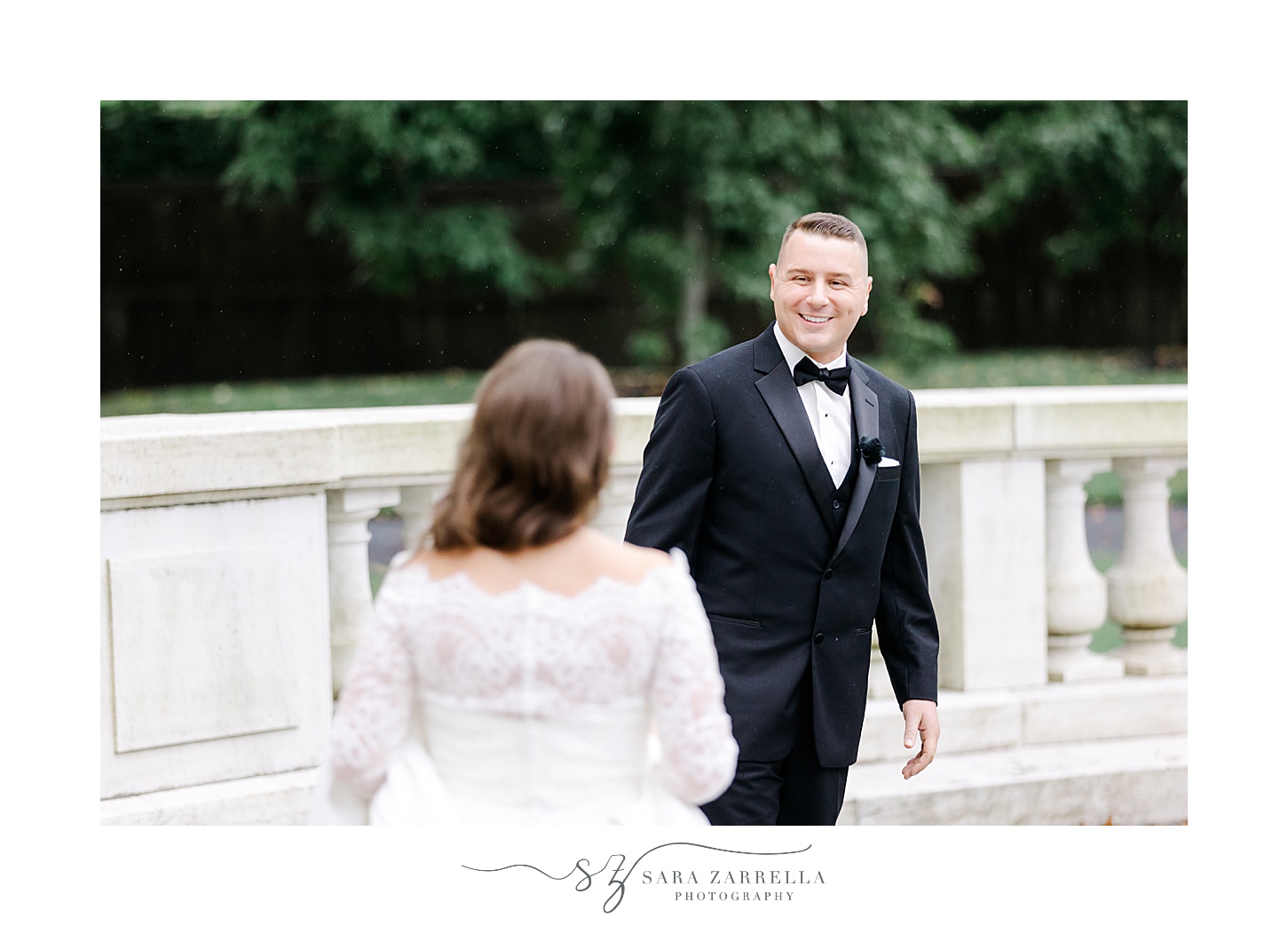 bride approaches groom for first look on balcony at Rosecliff Mansion