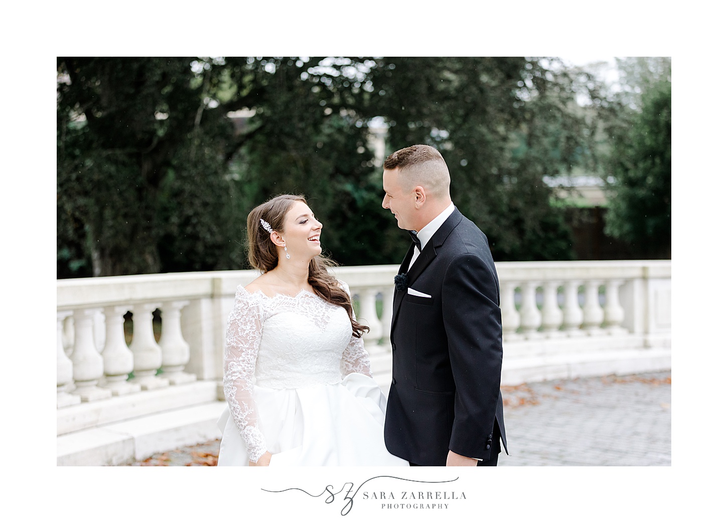 bride and groom smile together on patio at Rosecliff Mansion