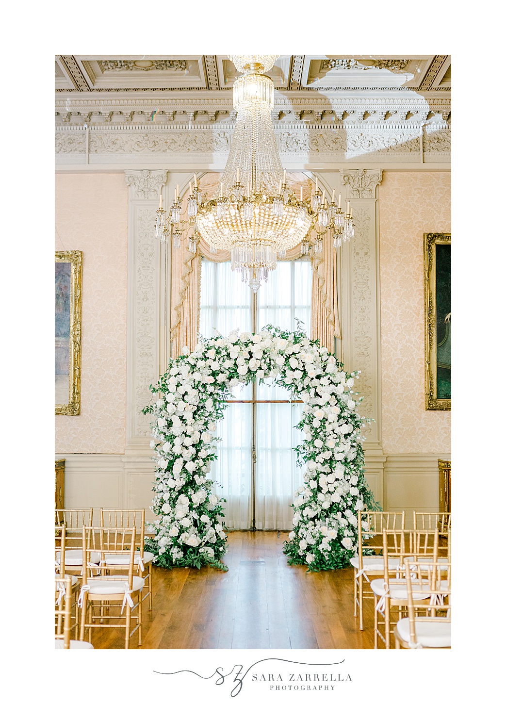 white floral arbor inside Rosecliff Mansion for wedding ceremony 