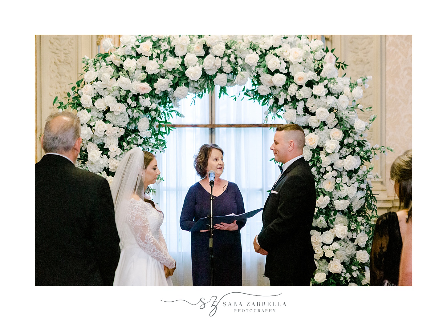 bride and groom exchange vows during winter wedding ceremony at Rosecliff Mansion