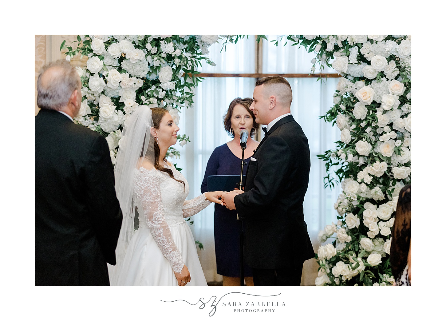 bride and groom smile during wedding ceremony at Rosecliff Mansion
