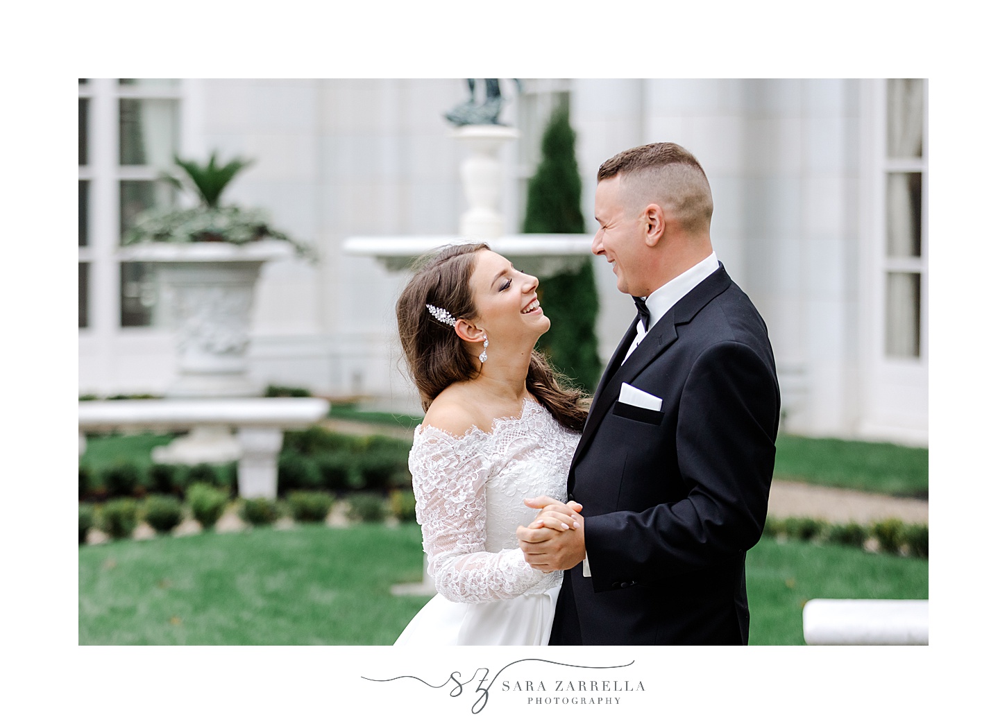 bride and groom hug in gardens of Rosecliff Mansion
