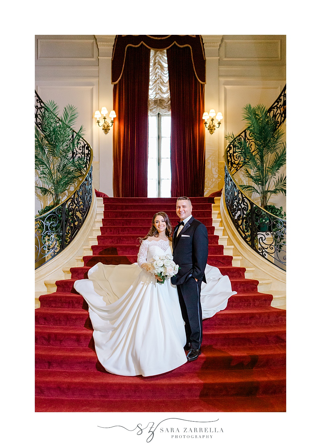 bride and groom walk down steps in historic Newport RI mansion