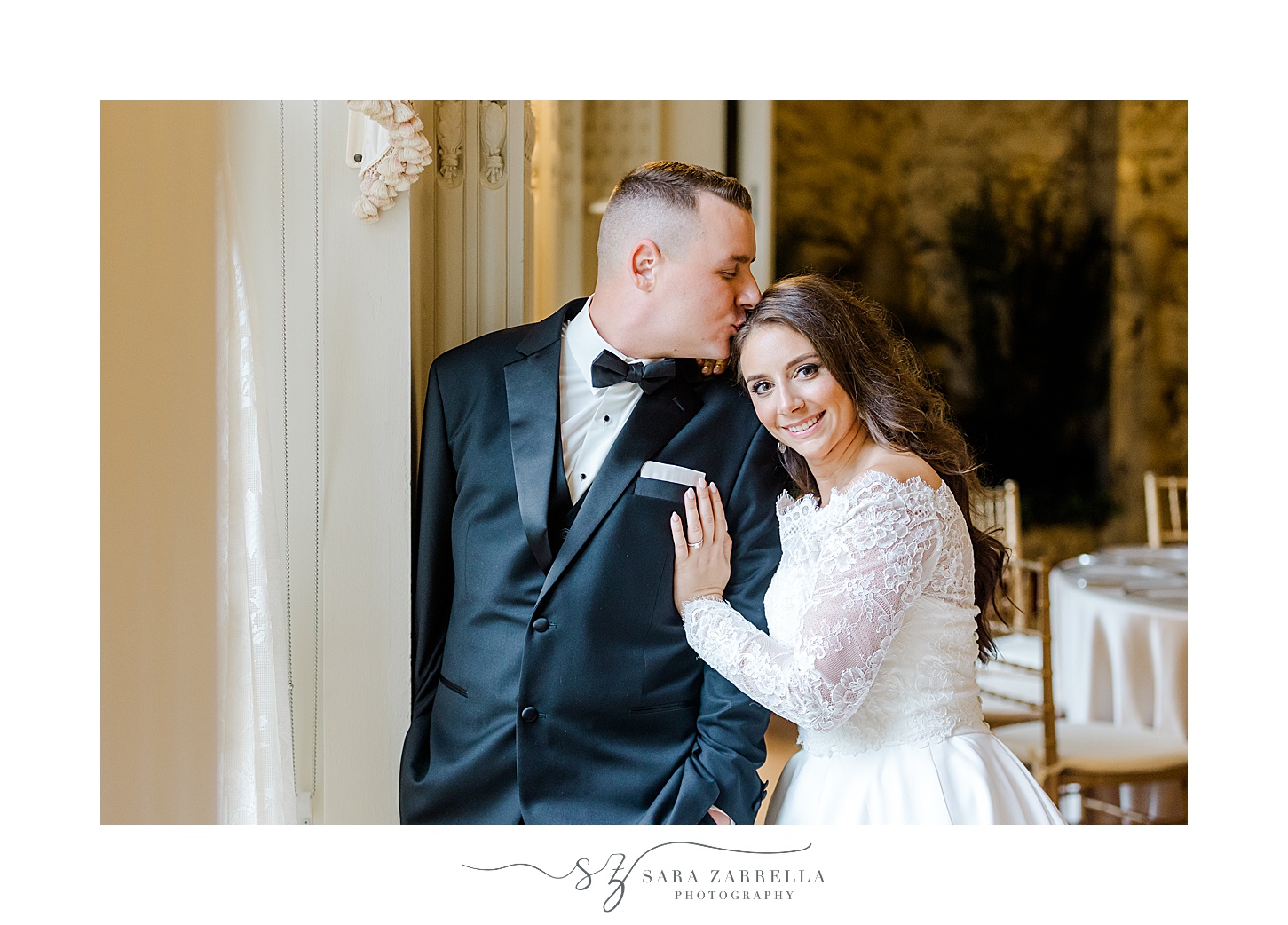 groom kisses bride's forehead leaning together inside historic Newport RI mansion