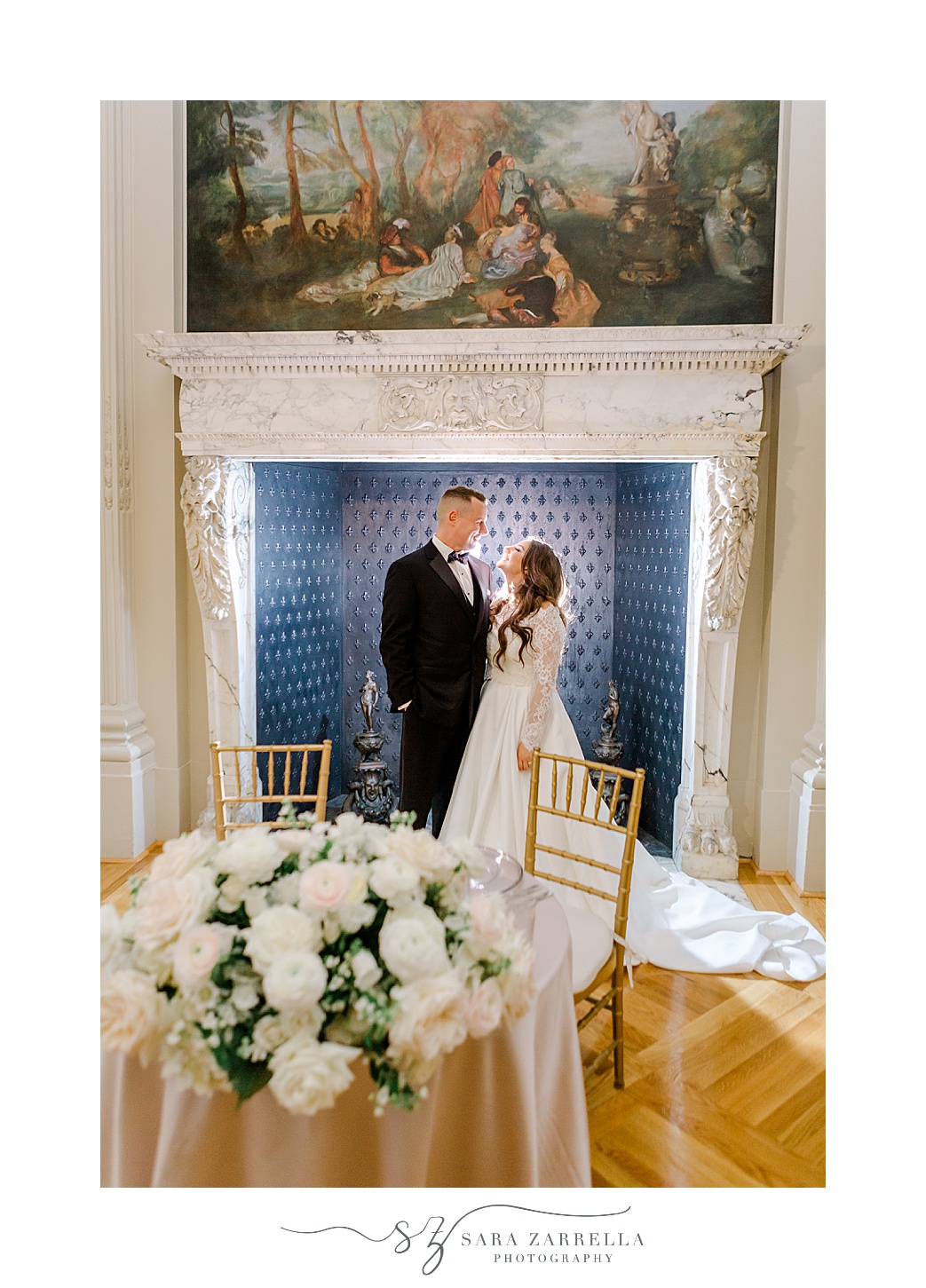 bride and groom hug in front of fireplace with blue tiles