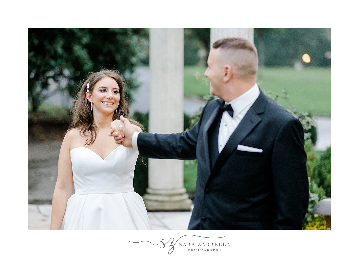 groom twirls bride during portraits in Rosecliff Mansion