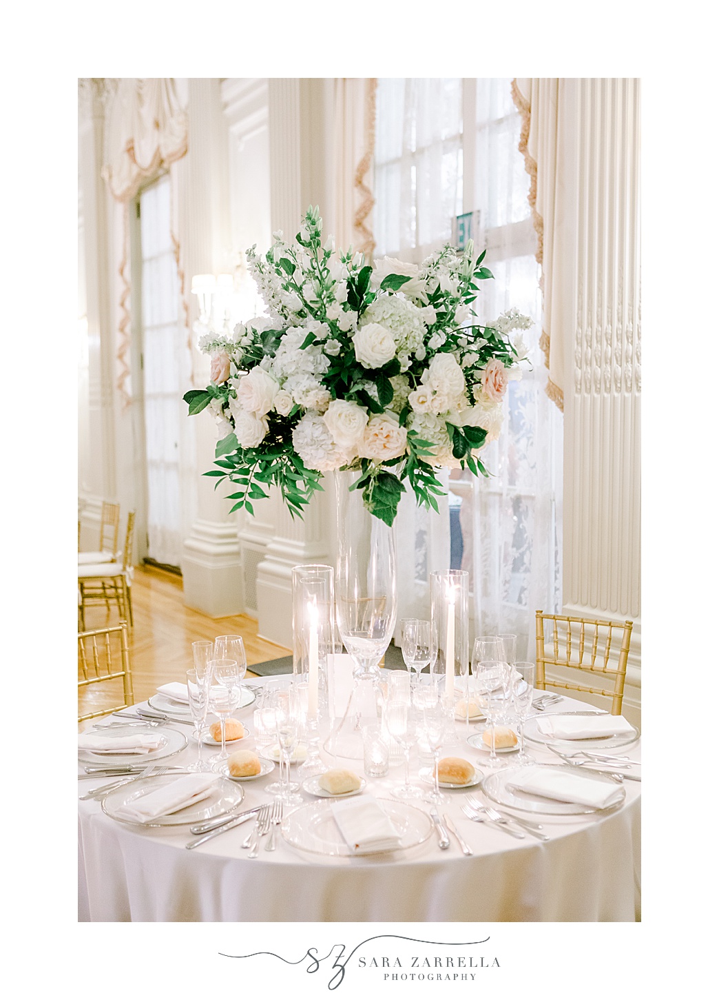 tall floral centerpiece with white and pink flowers at Rosecliff Mansion