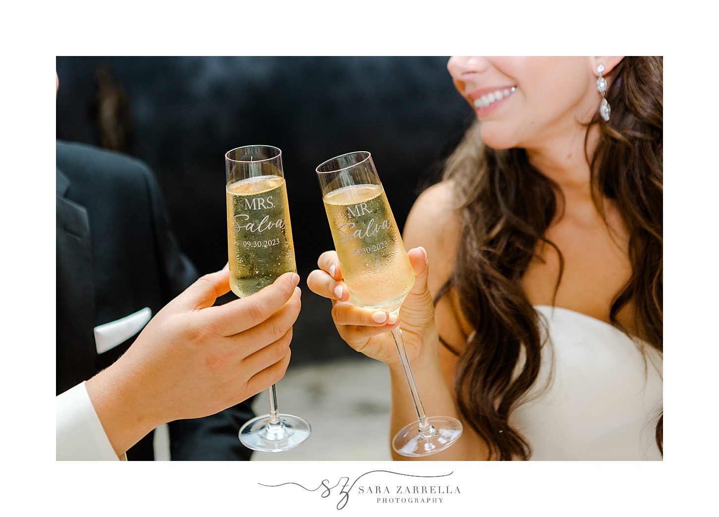 newlyweds tap glasses of champagne together 