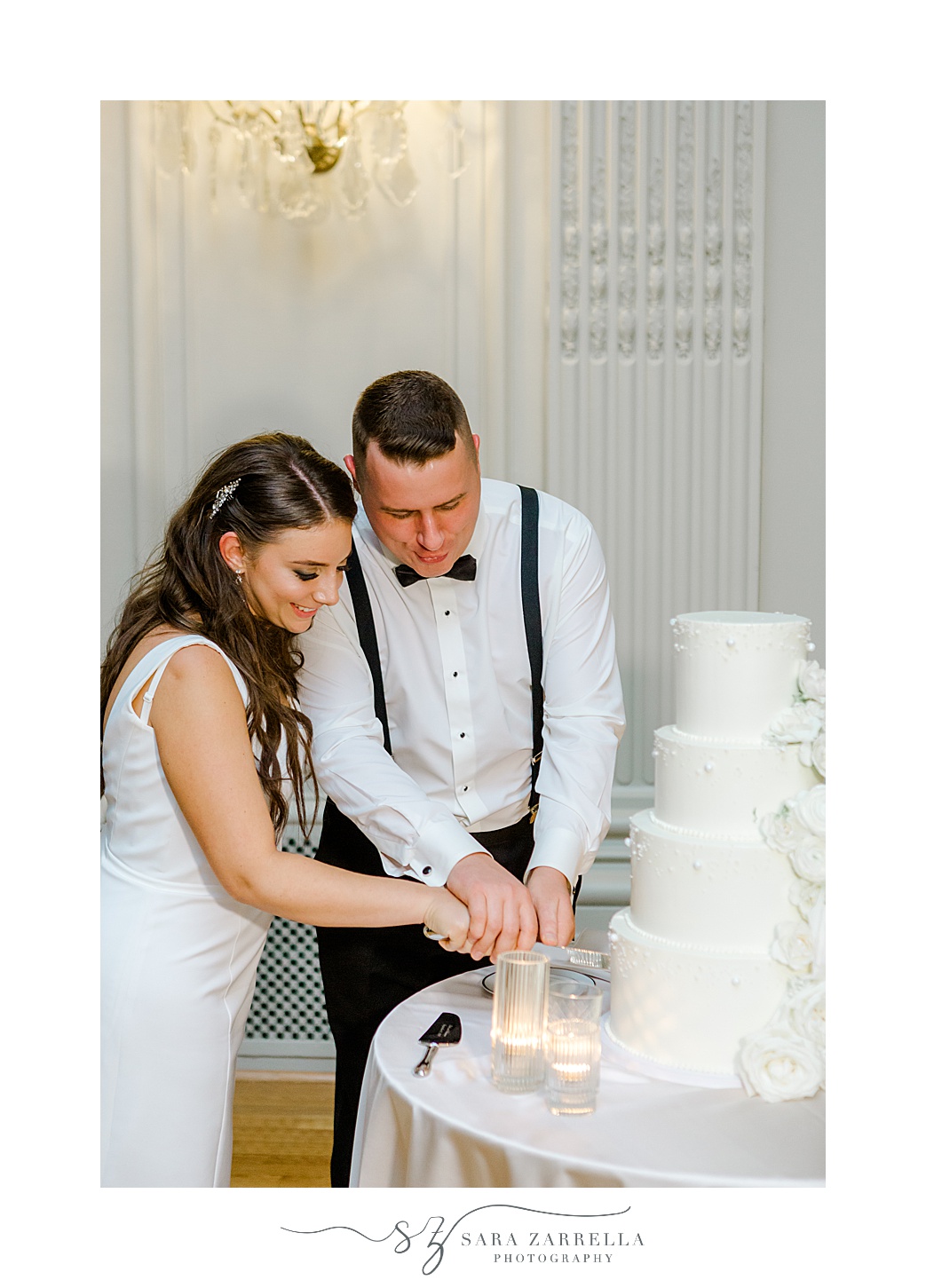 newlyweds cut wedding cake during Newport RI wedding reception