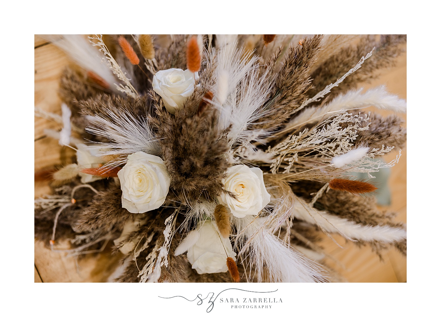 bride's boho bouquet with feathers and white flowers
