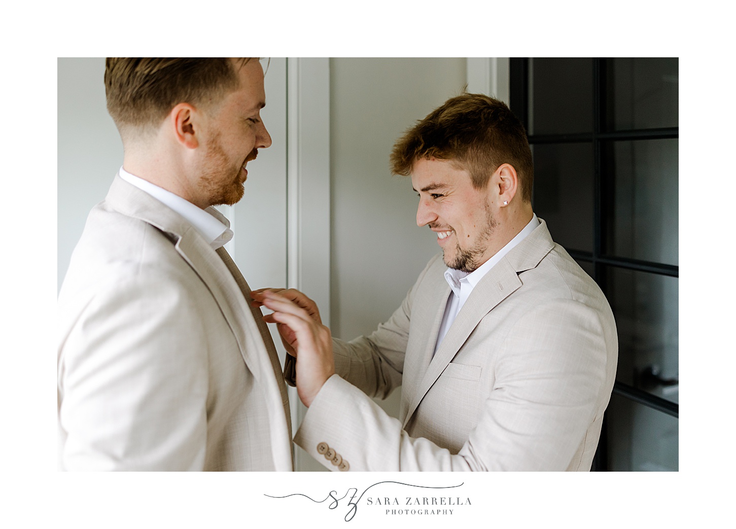 groom helps groom with feathery boutonnière