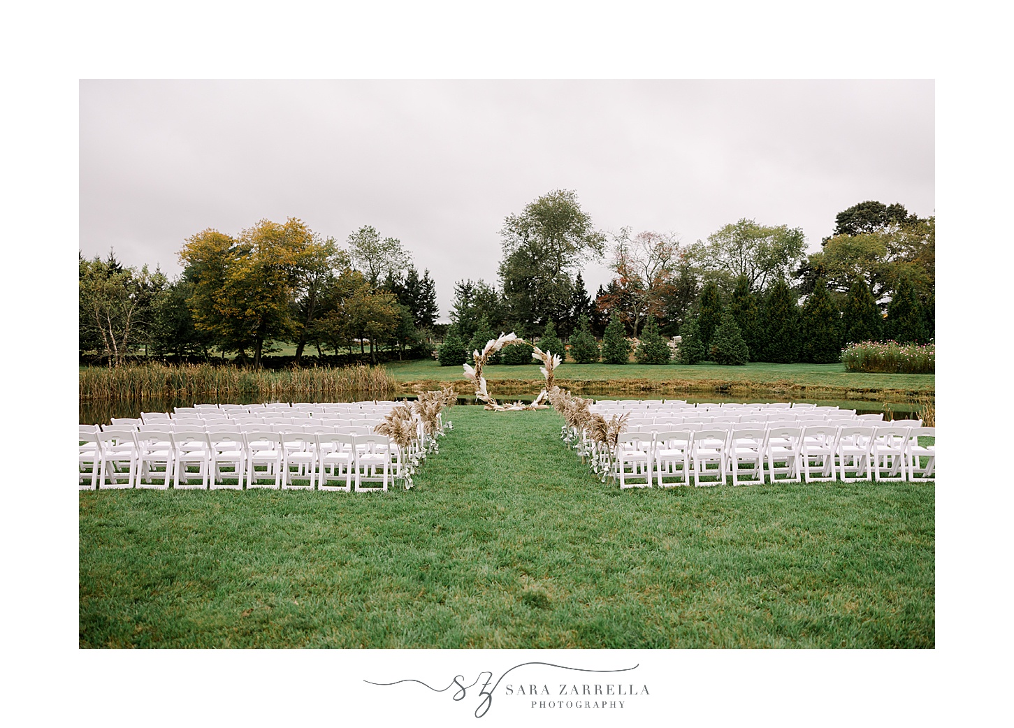 Rhode Island wedding ceremony on green lawn with white chairs