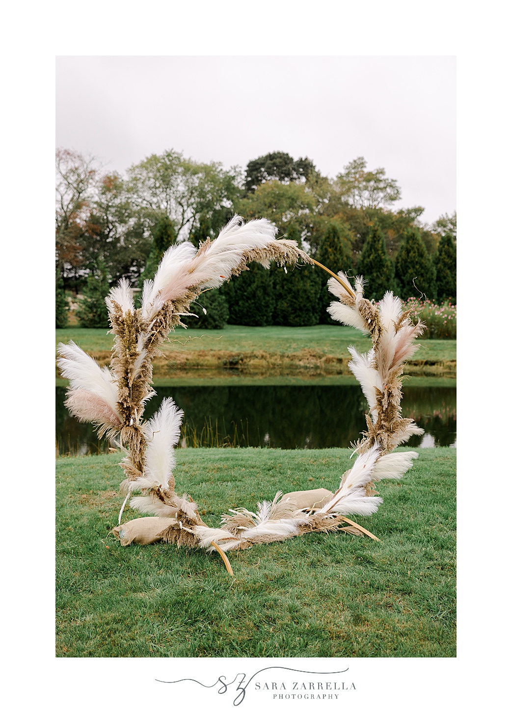 circular floral arbor with boho feathers and flowers for ceremony