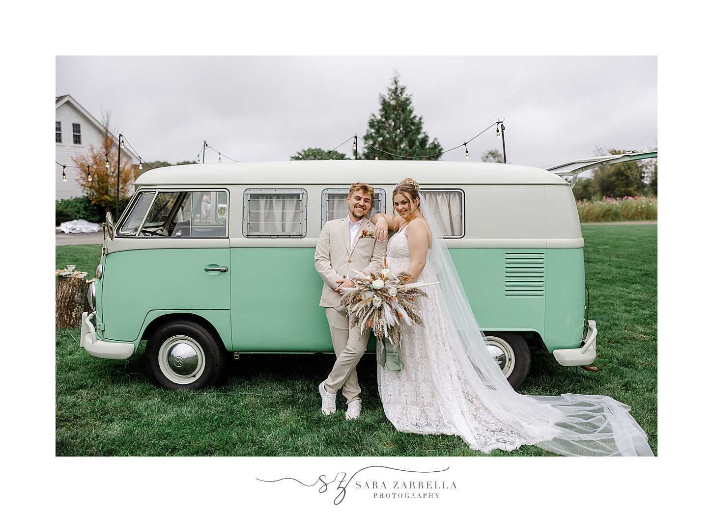 bride and groom sit by VW bus photo booth
