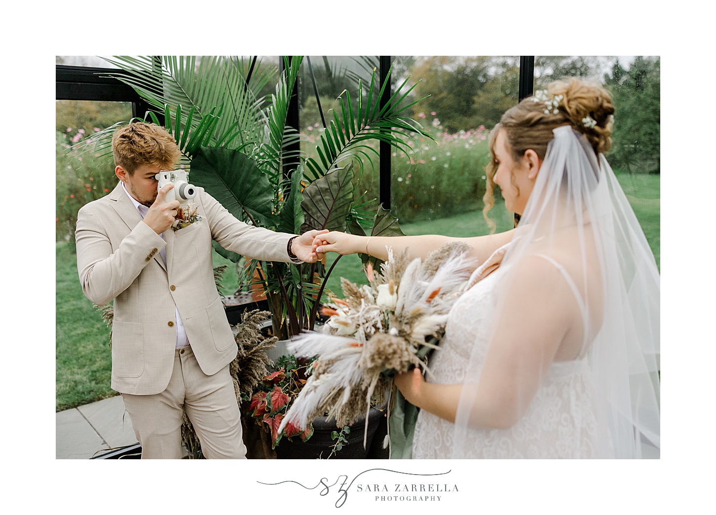 groom takes photo of bride with Polaroid camera